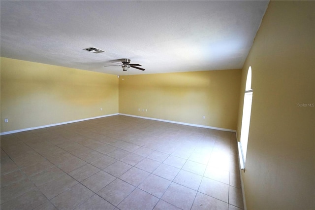 3329 White Blossom Ln, Clermont, FL 34711 - tiled empty room featuring a ceiling fan, baseboards, and a textured ceiling