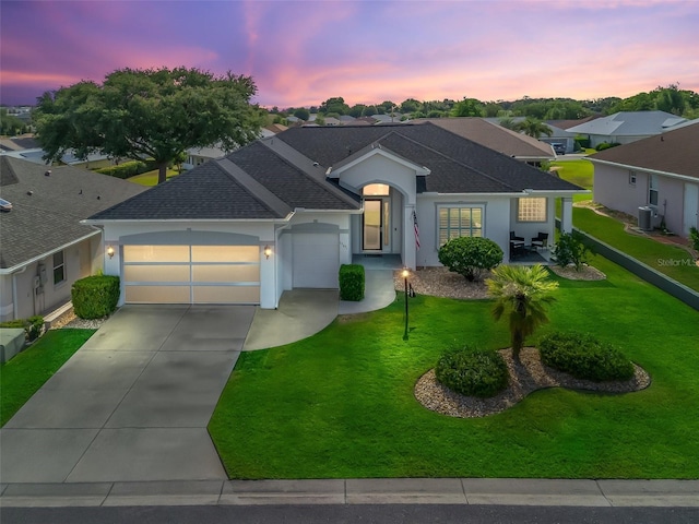 17471 SE 110th Ter, Summerfield, FL 34491 - single story home with a garage, roof with shingles, central AC, concrete driveway, and a front lawn
