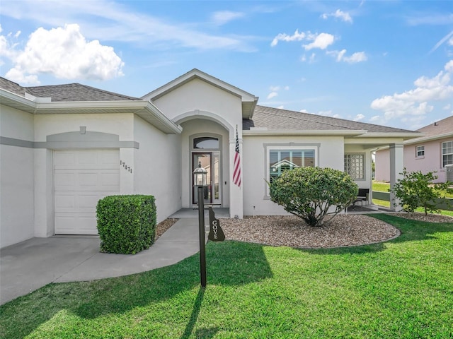 17471 SE 110th Ter, Summerfield, FL 34491 - view of front of property featuring a garage, a front lawn, and stucco siding