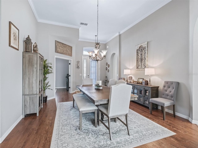 17471 SE 110th Ter, Summerfield, FL 34491 - dining room with arched walkways, a chandelier, crown molding, and dark wood-style floors