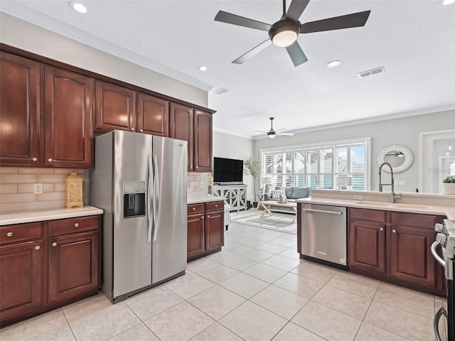 17471 SE 110th Ter, Summerfield, FL 34491 - kitchen featuring appliances with stainless steel finishes, a sink, ceiling fan, light countertops, and tasteful backsplash