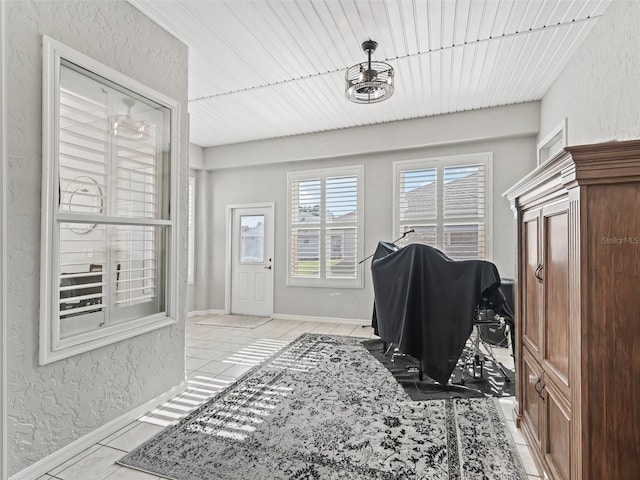 17471 SE 110th Ter, Summerfield, FL 34491 - interior space featuring a textured wall, light tile patterned flooring, and baseboards