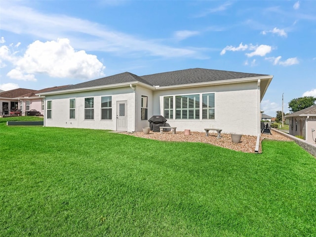 17471 SE 110th Ter, Summerfield, FL 34491 - rear view of property with stucco siding and a yard