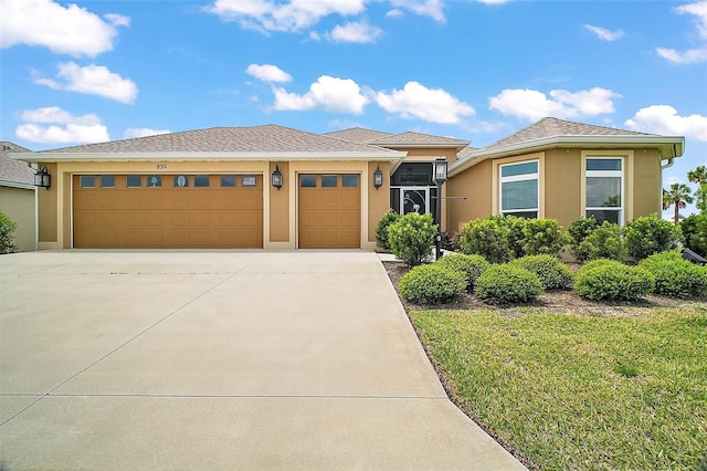 892 Hubbard Loop, The Villages, FL 32163 - view of front of property featuring concrete driveway, an attached garage, stucco siding, and a front lawn