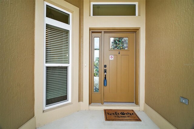 892 Hubbard Loop, The Villages, FL 32163 - view of exterior entry featuring stucco siding