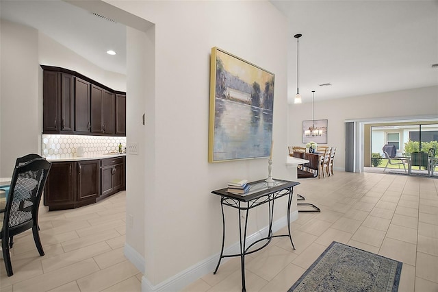 892 Hubbard Loop, The Villages, FL 32163 - hallway featuring a chandelier, light tile patterned flooring, baseboards, and recessed lighting