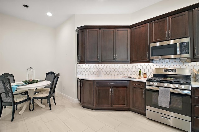 892 Hubbard Loop, The Villages, FL 32163 - kitchen featuring stainless steel appliances, light countertops, tasteful backsplash, dark brown cabinetry, and recessed lighting