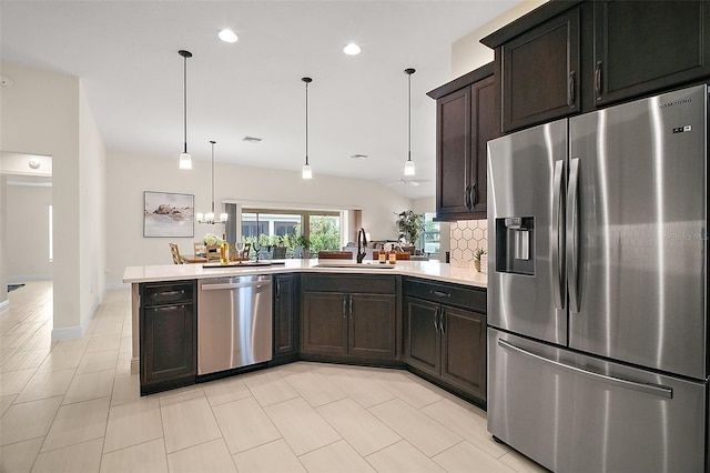892 Hubbard Loop, The Villages, FL 32163 - kitchen featuring stainless steel appliances, a sink, light countertops, a peninsula, and hanging light fixtures
