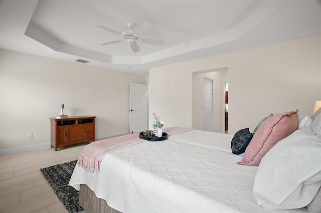 892 Hubbard Loop, The Villages, FL 32163 - bedroom featuring a tray ceiling, baseboards, and ceiling fan
