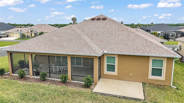 892 Hubbard Loop, The Villages, FL 32163 - rear view of house with a lawn, a shingled roof, a patio area, and a residential view