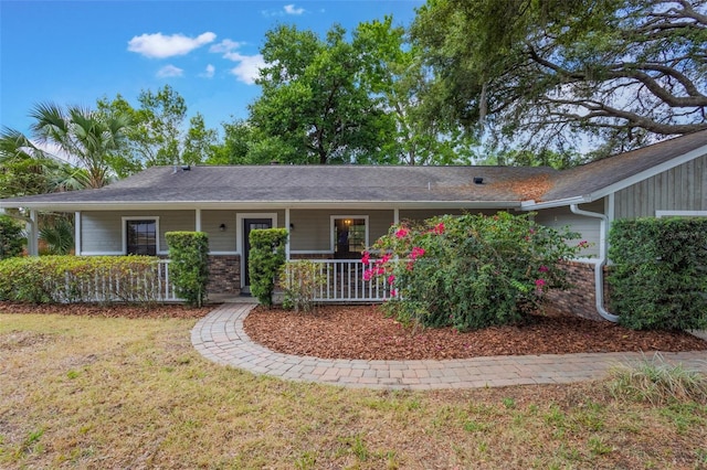 8410 Lake Bosse Dr, Orlando, FL 32810 - ranch-style home featuring covered porch and a front yard