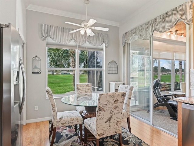 11820 SE 178th St, Summerfield, FL 34491 - dining area with light wood-style floors, ornamental molding, a ceiling fan, and baseboards