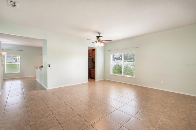 356 Giovani Blvd, Clermont, FL 34715 - empty room with light tile patterned floors, plenty of natural light, and ceiling fan