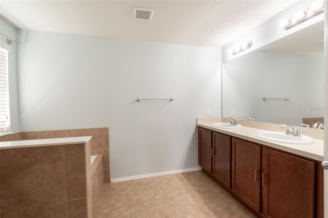 356 Giovani Blvd, Clermont, FL 34715 - full bath featuring double vanity, tile patterned flooring, and a relaxing tiled tub