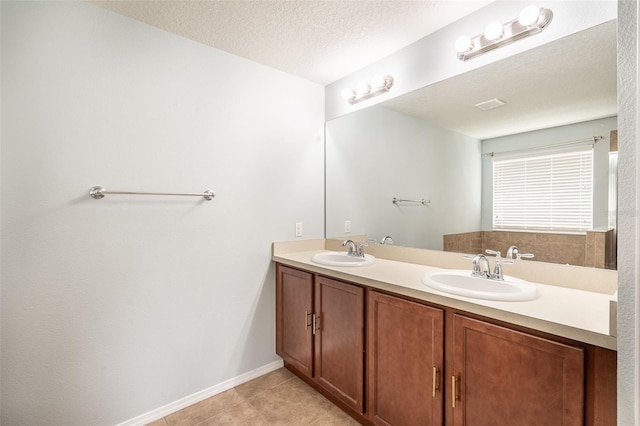 356 Giovani Blvd, Clermont, FL 34715 - full bathroom featuring double vanity, tile patterned floors, and a textured ceiling