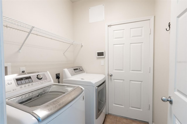 356 Giovani Blvd, Clermont, FL 34715 - washroom featuring washer and clothes dryer and light tile patterned flooring
