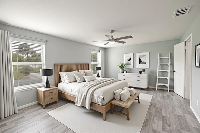 356 Giovani Blvd, Clermont, FL 34715 - bedroom with multiple windows, light wood-type flooring, and a ceiling fan
