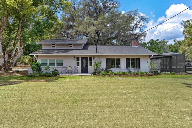 43411 State Road 19, Altoona, FL 32702 - rear view of property with a chimney, a lawn, and roof with shingles