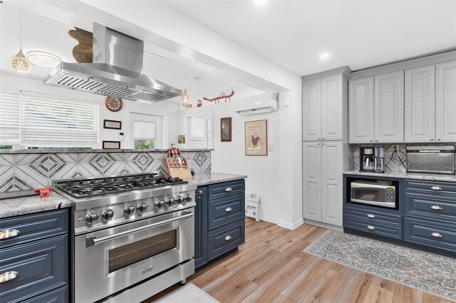 43411 State Road 19, Altoona, FL 32702 - kitchen with stainless steel stove, blue cabinets, wall chimney exhaust hood, backsplash, and recessed lighting