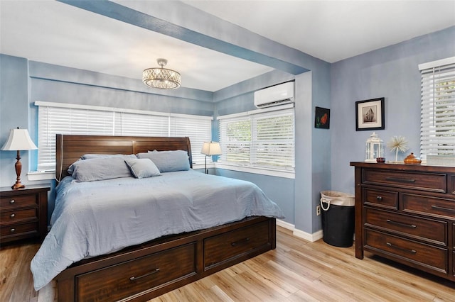 43411 State Road 19, Altoona, FL 32702 - bedroom with light wood-style floors, a wall unit AC, baseboards, and multiple windows