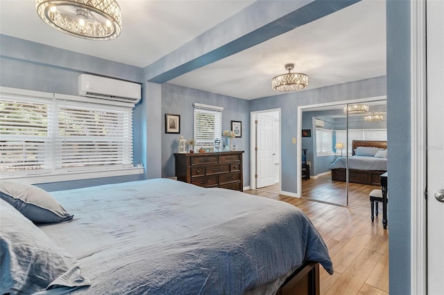 43411 State Road 19, Altoona, FL 32702 - bedroom with a chandelier, a wall mounted air conditioner, wood finished floors, and baseboards