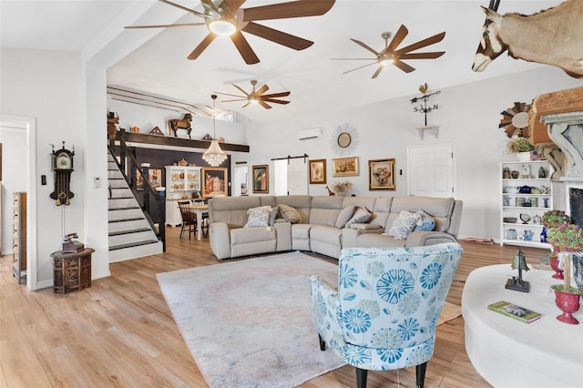 43411 State Road 19, Altoona, FL 32702 - living room with stairway, a ceiling fan, a barn door, wood finished floors, and lofted ceiling