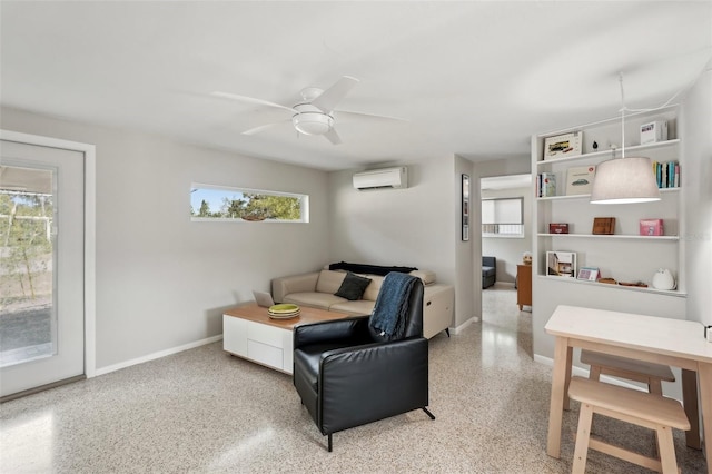 4125 Worcester Rd, Sarasota, FL 34231 - living area featuring a wall mounted air conditioner, dark aggregate flooring, ceiling fan, and baseboards