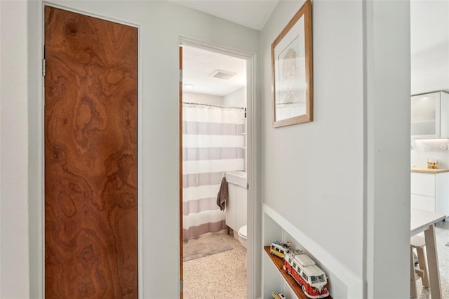 4125 Worcester Rd, Sarasota, FL 34231 - bathroom featuring toilet, speckle patterned floor, and curtained shower