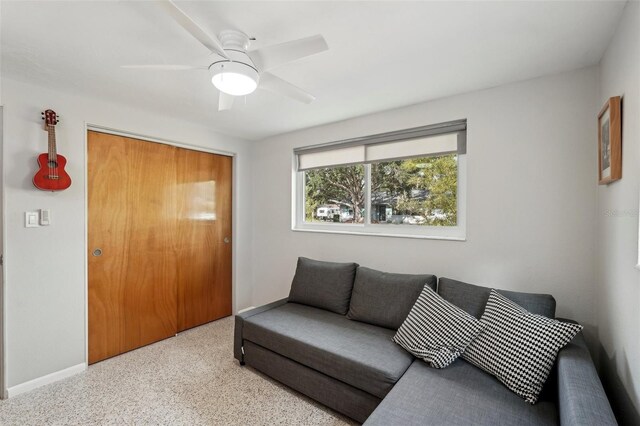 4125 Worcester Rd, Sarasota, FL 34231 - living room with speckle patterned floor, baseboards, and a ceiling fan