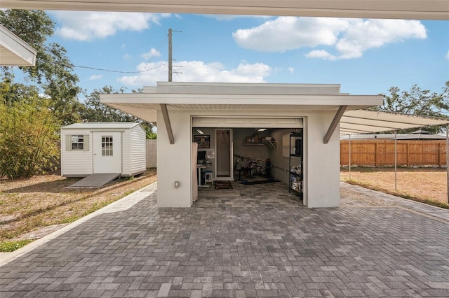 4125 Worcester Rd, Sarasota, FL 34231 - view of patio / terrace featuring an outbuilding, fence, a storage shed, and a garage