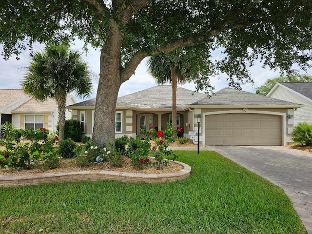 ranch-style house featuring a front yard, stucco siding, driveway, and a garage