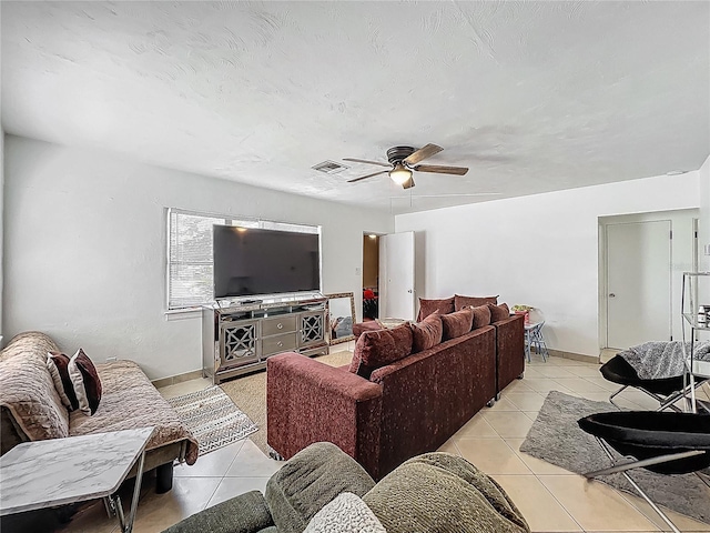 living room with a ceiling fan, baseboards, light tile patterned floors, and visible vents
