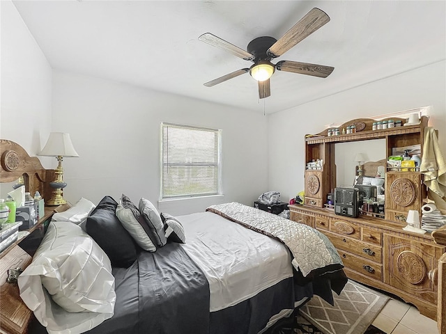 bedroom with ceiling fan and light tile patterned flooring