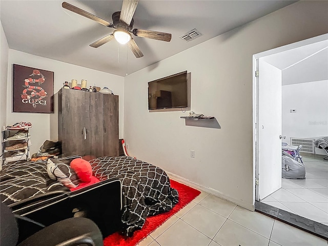 tiled bedroom with visible vents and ceiling fan