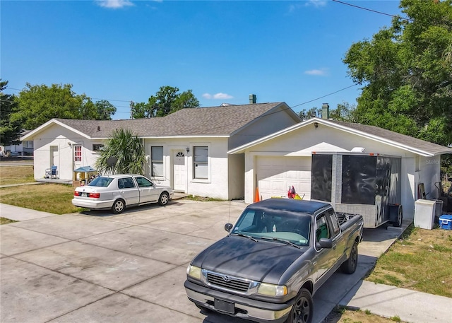 ranch-style home featuring driveway, stucco siding, a shingled roof, and a garage