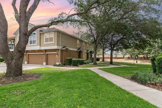 866 Ashworth Overlook Dr Unit B, Apopka, FL 32712 - view of home's exterior with stucco siding, an attached garage, a yard, and concrete driveway