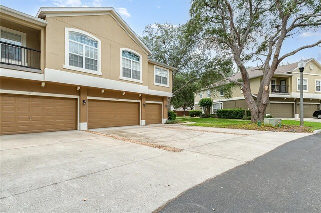 866 Ashworth Overlook Dr Unit B, Apopka, FL 32712 - view of property exterior with stucco siding, concrete driveway, and a garage