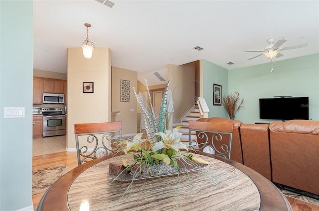 866 Ashworth Overlook Dr Unit B, Apopka, FL 32712 - dining space with stairs, ceiling fan, and light wood-style floors