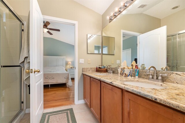866 Ashworth Overlook Dr Unit B, Apopka, FL 32712 - ensuite bathroom featuring vaulted ceiling, a ceiling fan, a shower stall, double vanity, and tile patterned flooring