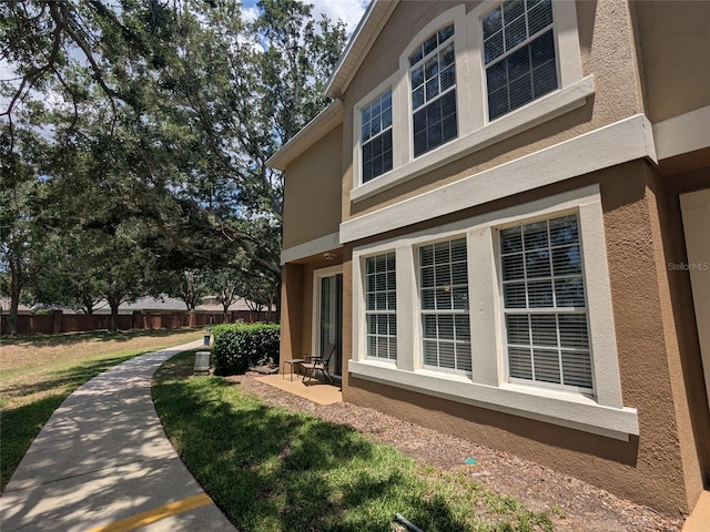 866 Ashworth Overlook Dr Unit B, Apopka, FL 32712 - view of side of property featuring stucco siding and a lawn