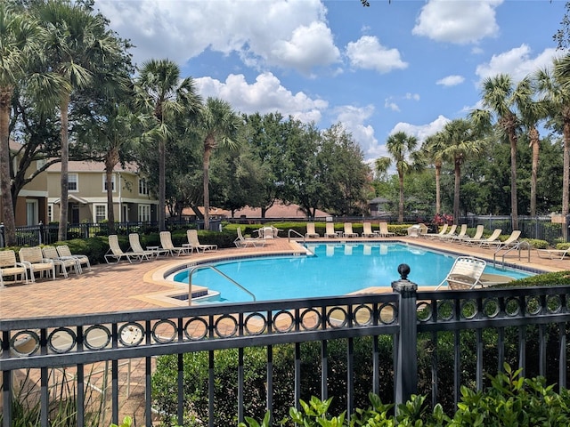 866 Ashworth Overlook Dr Unit B, Apopka, FL 32712 - community pool with fence, a patio, and view of wooded area