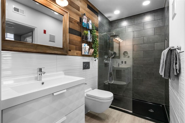 bathroom with walk in shower, tile walls, toilet, and visible vents