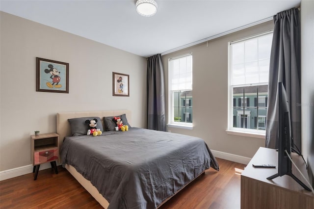 bedroom featuring baseboards and wood finished floors
