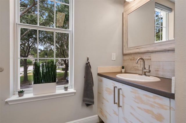 bathroom with vanity and decorative backsplash