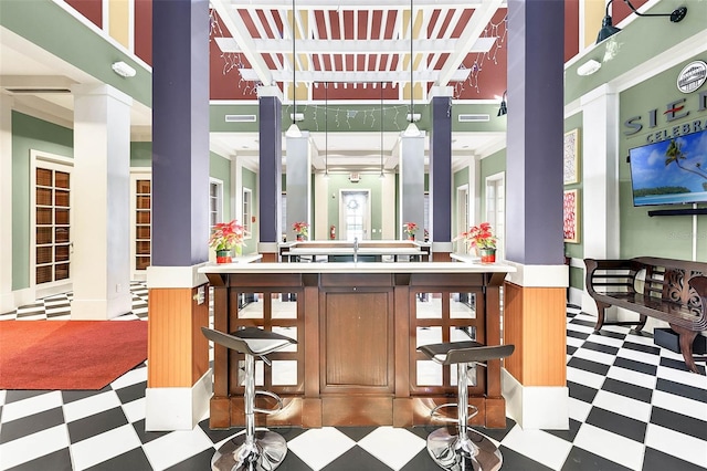 bar with tile patterned floors and a sink