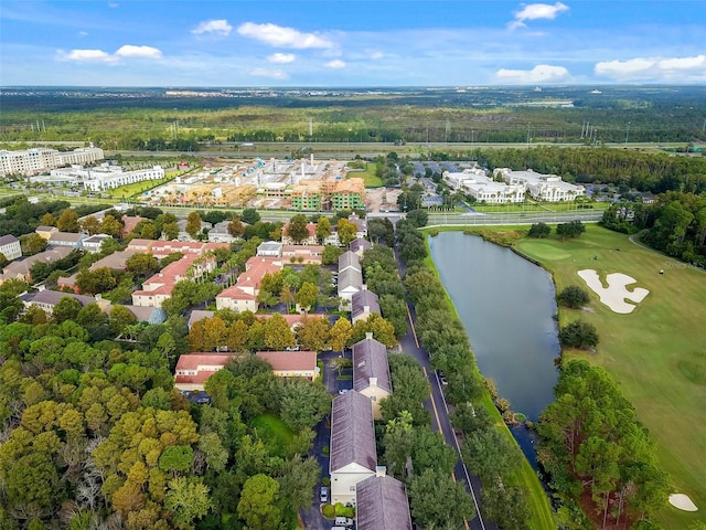 drone / aerial view with a water view and golf course view