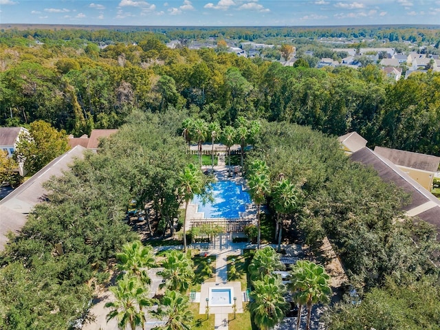 birds eye view of property with a view of trees