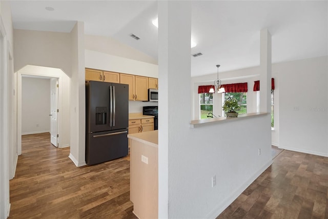 kitchen featuring black fridge, range, stainless steel microwave, light countertops, and dark wood-type flooring