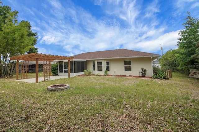 back of house with a pergola, stucco siding, a fire pit, a sunroom, and a patio