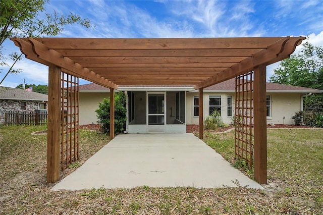 view of patio / terrace with a pergola, a sunroom, and a carport